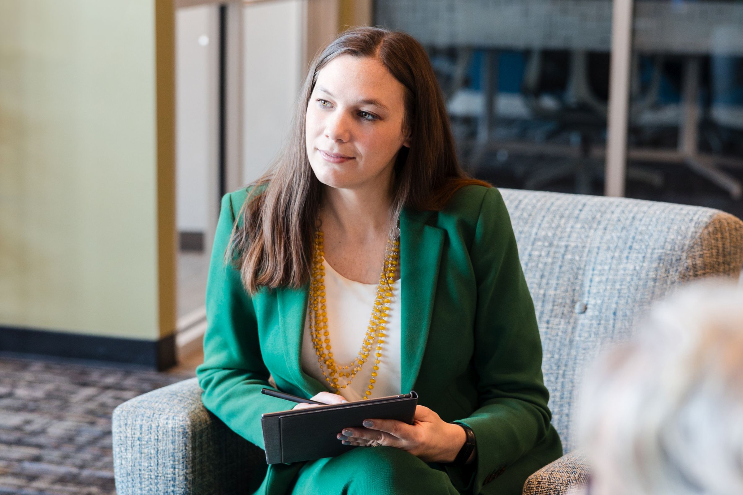 Accounting Professional takes notes during a meeting.